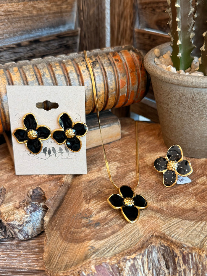 Black floral stud earrings with gold-tone petal frame and matching necklace pendant