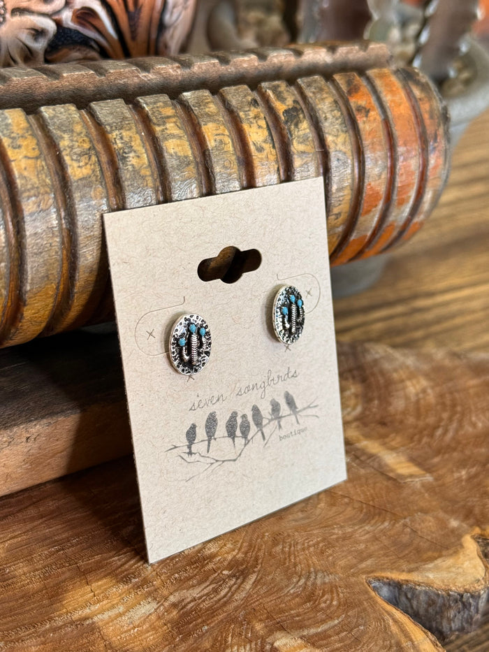 Turquoise oval stud earrings with textured dark silver frame and matching posts
