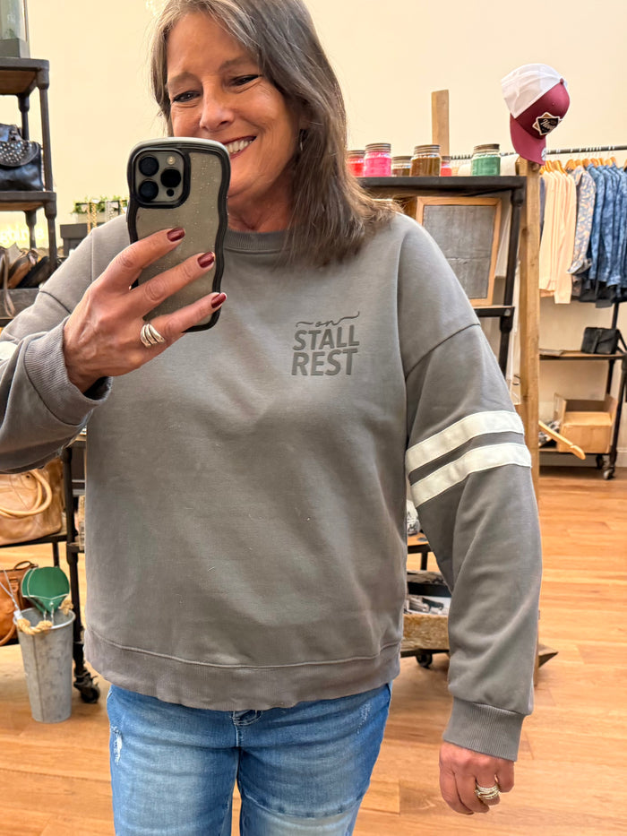 Gray sweatshirt front view with crew neck and 'STALL REST' logo