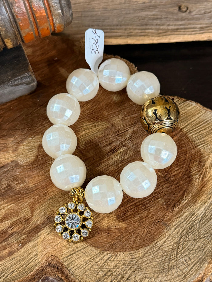 Pearl gold crystal charm stretch bracelet featuring white faceted bead strands and gold crystal flower