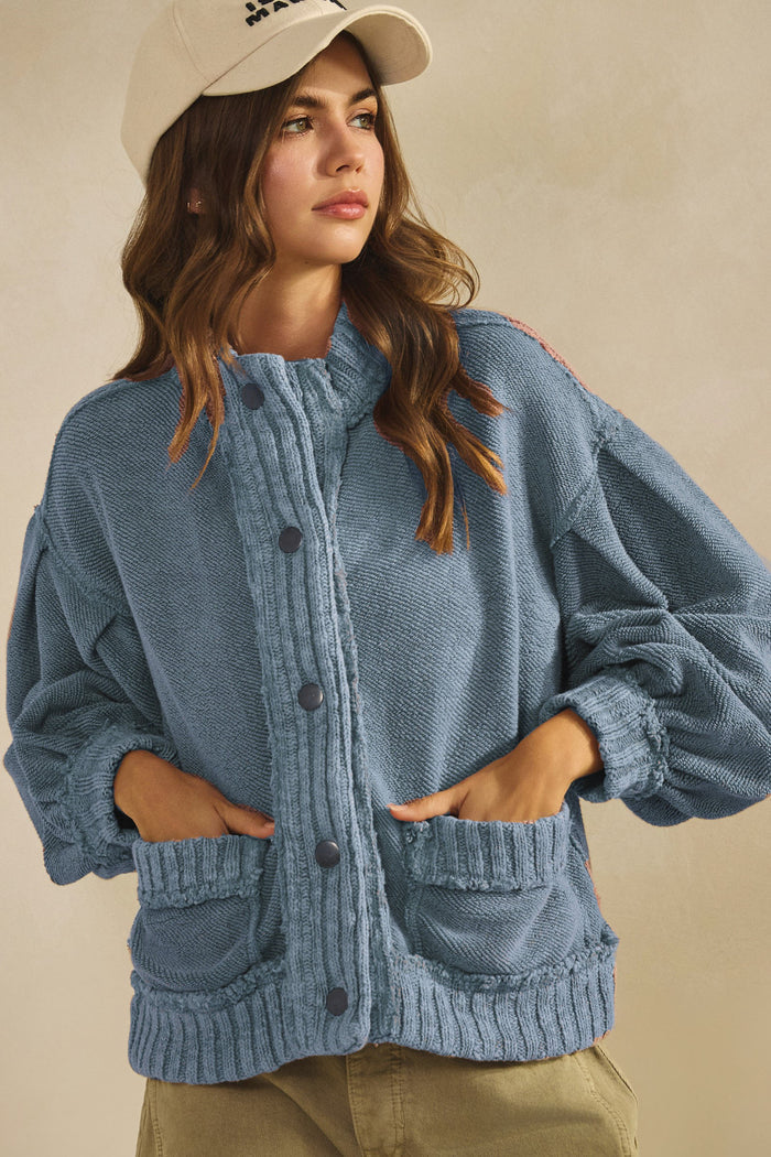 Washed blue cotton snap-front cardigan with ribbed cuffs and two front pockets