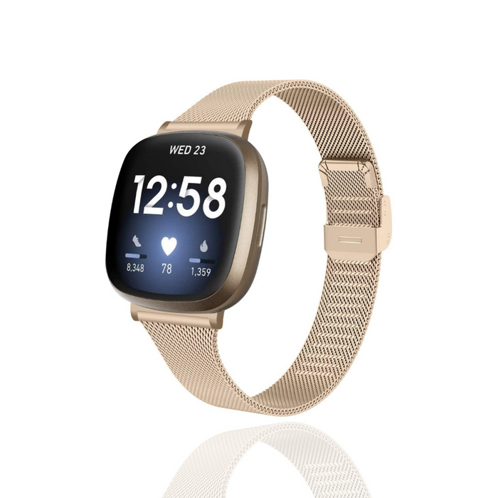 Gold Milanese mesh Fitbit strap by Coconut Lane, shown with time, date, heart rate, steps, and heart icon on display.