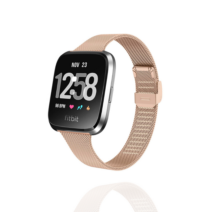 Fitbit watch with a slim rose gold Milanese strap, displaying time, date, and activity icons on its screen.
