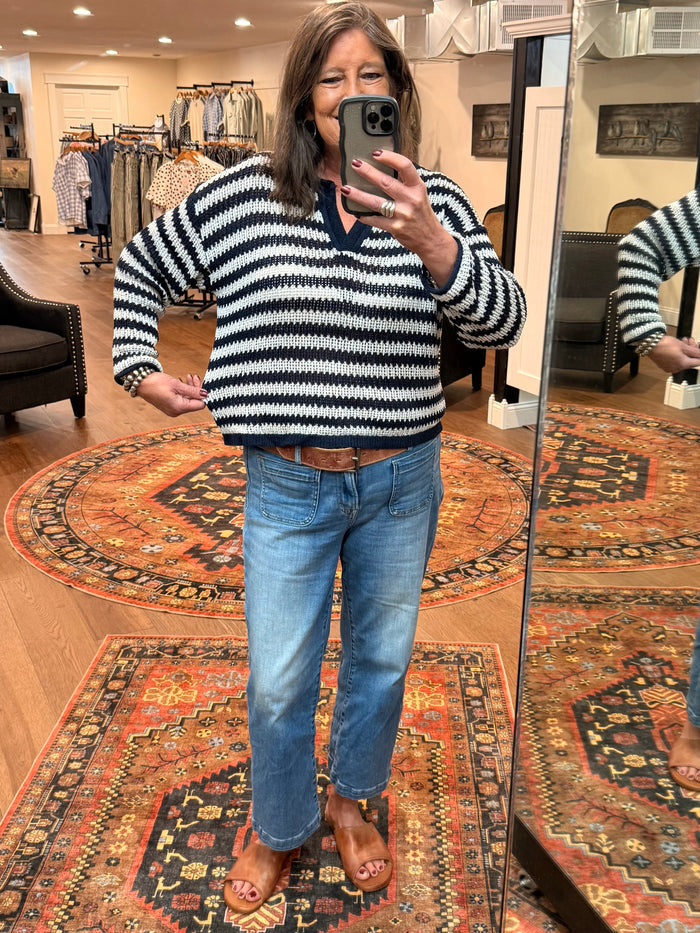 Navy and white striped loose knit sweater with raw-edged hem, wide sleeves