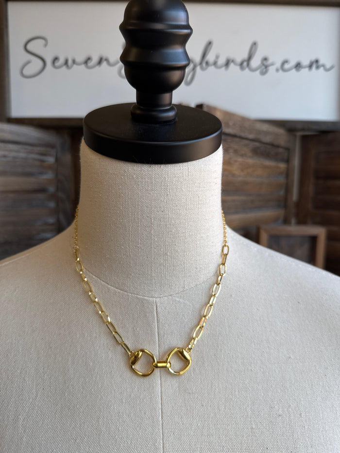 Gold-tone snaffle bit necklace with chain and double-ring pendant