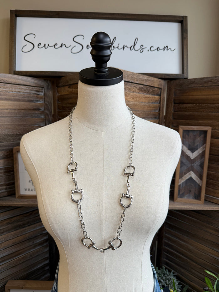 Silver-tone triple snaffle bit necklace with three linked rings and long chain