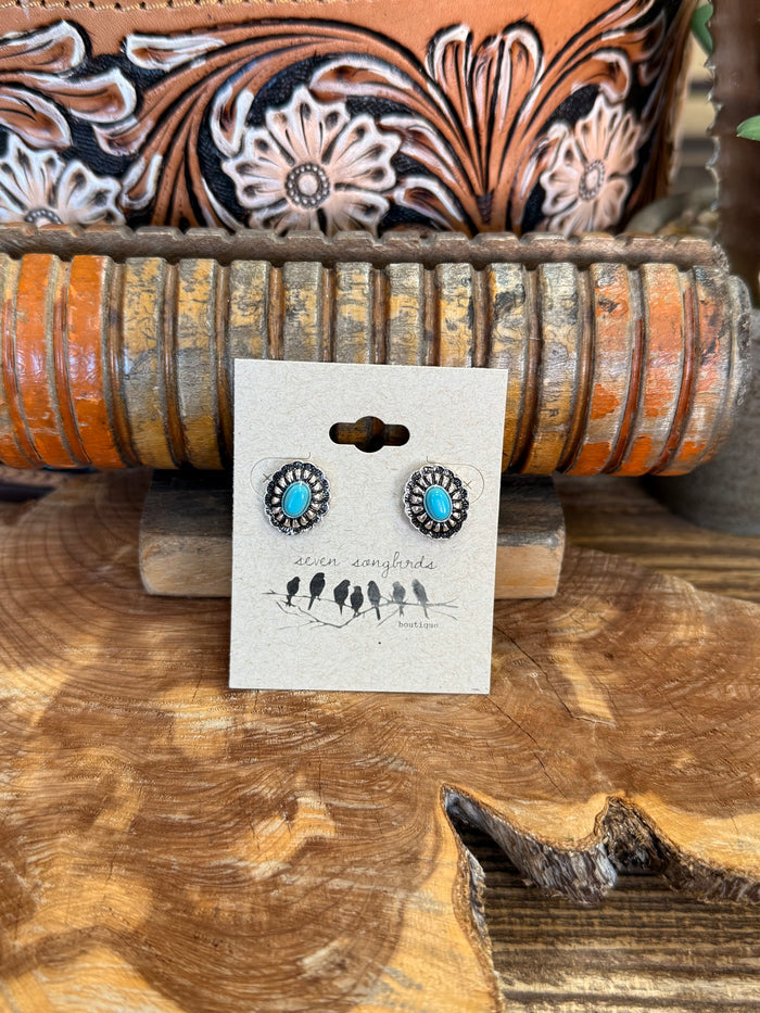 Large silver-tone concho stud earrings with turquoise center discs