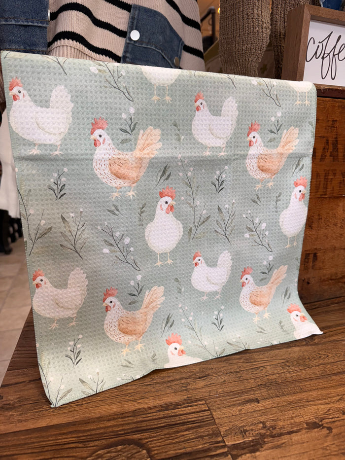 Light sage towel with repeating white and orange chicken pattern