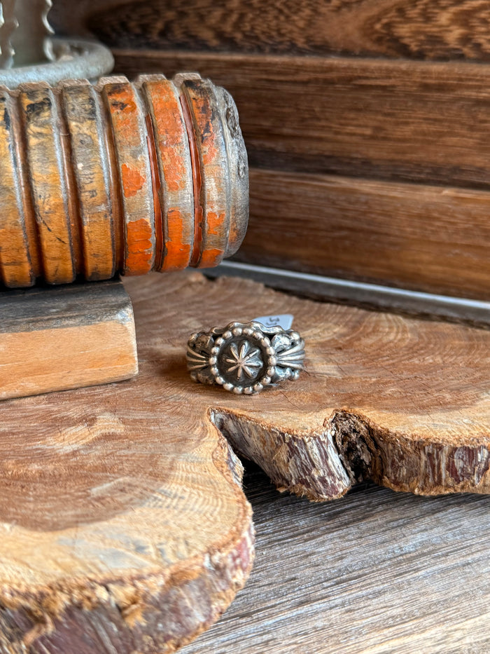 Chunky sterling silver ring with sunburst center and raised bead border