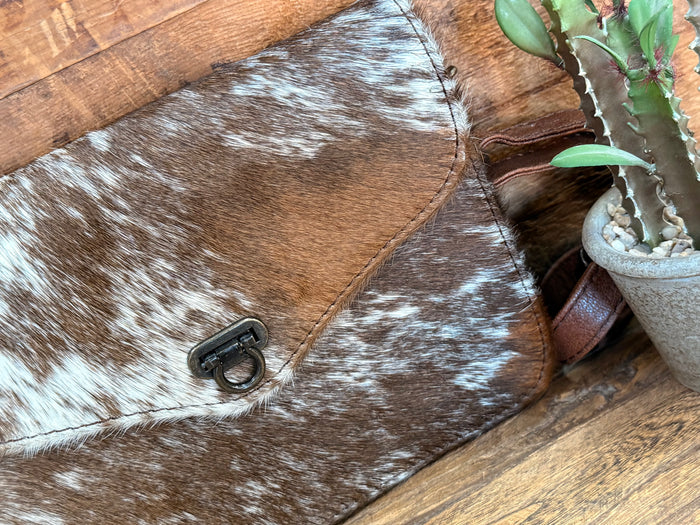 Close-up mini flap crossbody purse with cowhide hair-on flap and metal clasp hardware