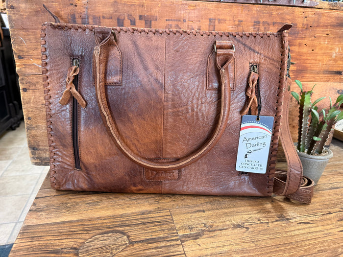 Brown leather briefcase tote with stitched seams and dual side pockets