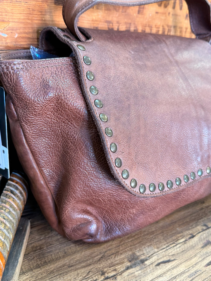 Chocolate leather crossbody purse with studded flap edge and wide shoulder strap