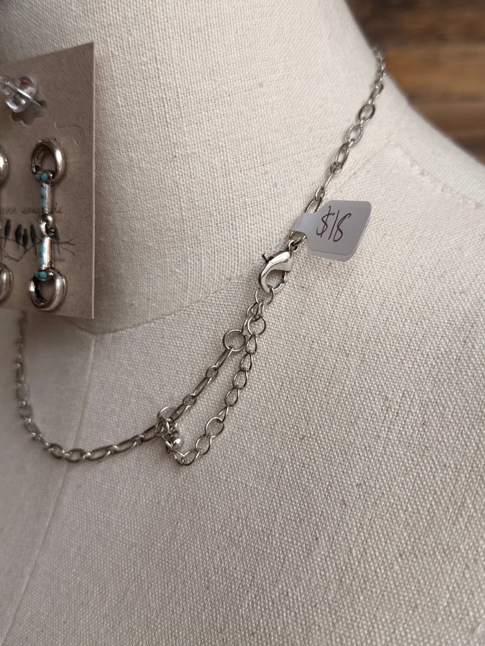 Silver chain necklace with turquoise-accent snaffle bit links and 5/8 size tag