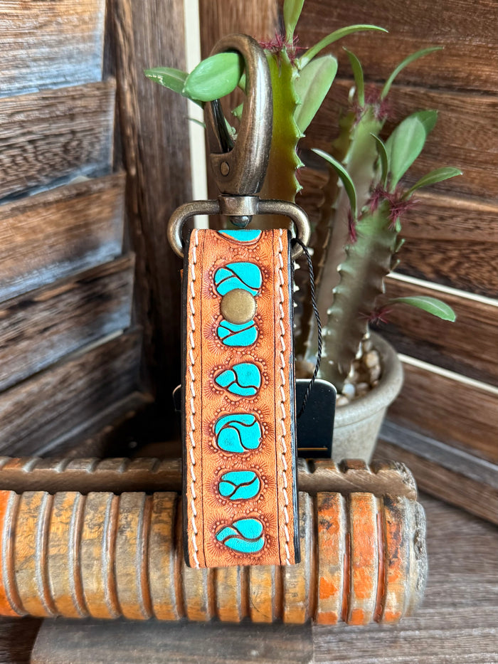 Orange-brown tooled leather keychain with turquoise stone inlays, stitched edge, key ring
