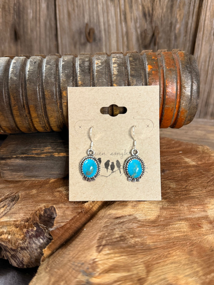 Turquoise oval fishhook earrings with silver beaded bezel and dangling hooks