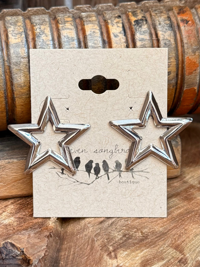 Silver star stud earrings: pair of large star studs on white jewelry card
