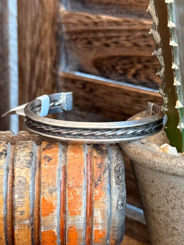 Silver metal cuff bracelet with wave-like engraving and turquoise inlay strip