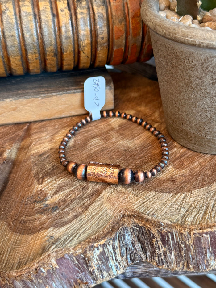 Copper barrel bead stretch bracelet with dark spacer beads