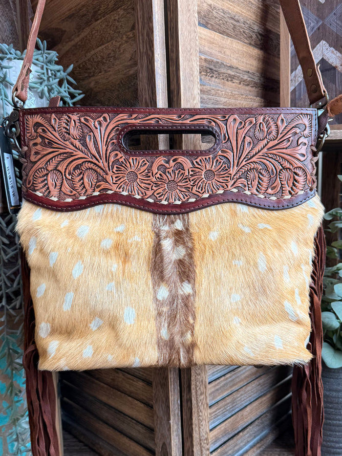 Cowhide deer print crossbody purse with floral tooled top panel and long fringe