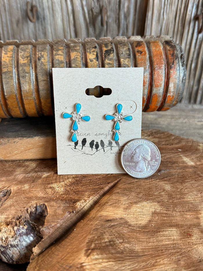 Sterling silver turquoise cross stud earrings, shown with coin for size