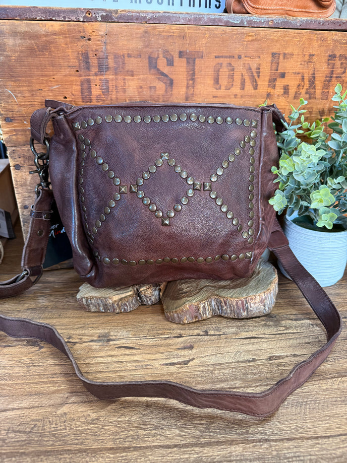 Chocolate brown studded zip-top crossbody purse with adjustable shoulder strap