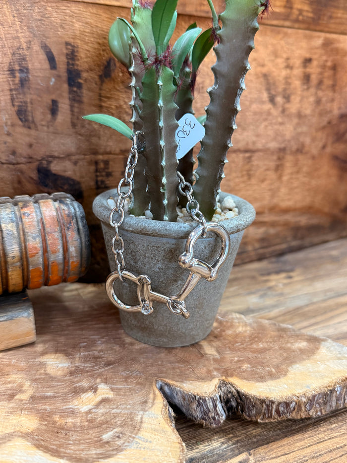 Silver snaffle bit bracelet with chain and linked D-ring charm