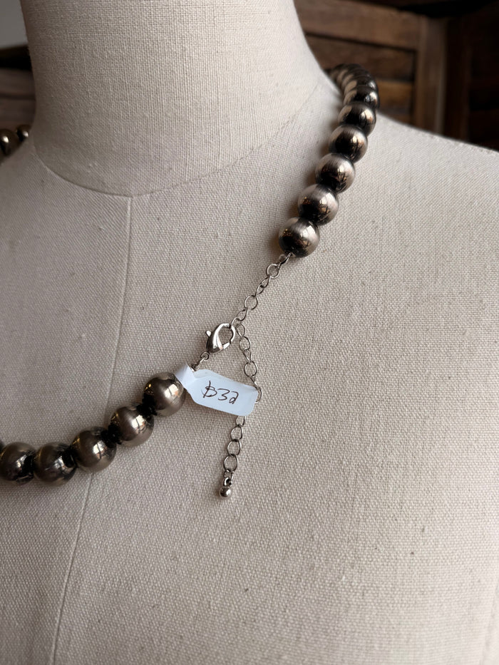Graduated silver pearl necklace clasp with small chain and charm tag