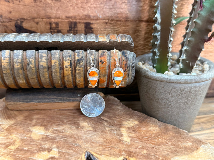 Handmade fishhook earrings with oval orange opal inlay, silver setting, with coin