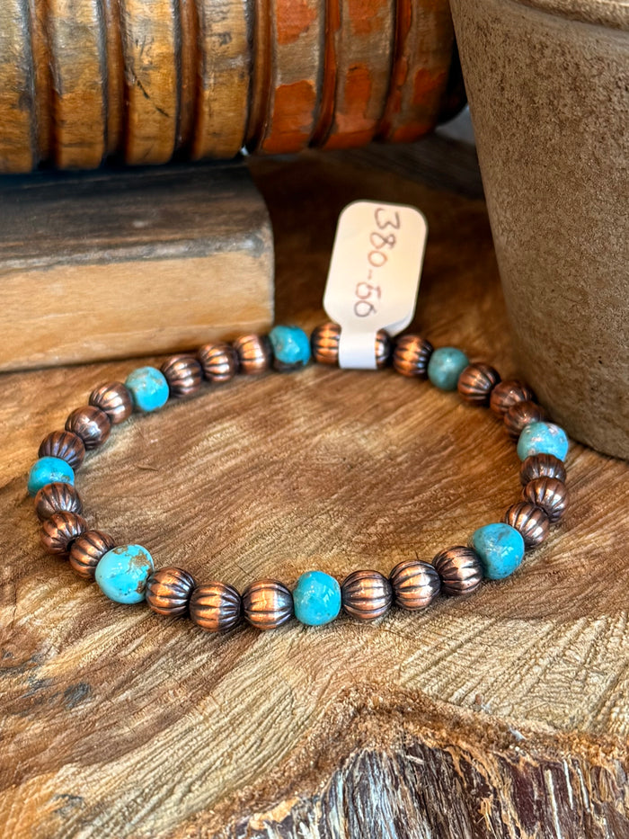 Stretch bracelet with copper ribbed beads and small turquoise round beads