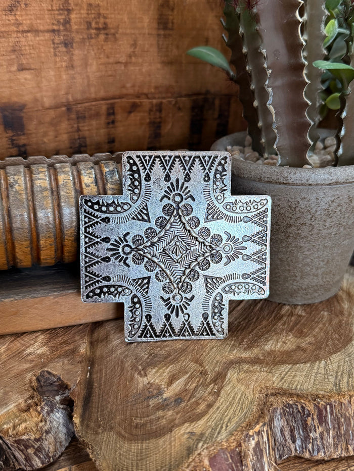 Cross belt buckle in silver metal with ornate engraved floral pattern