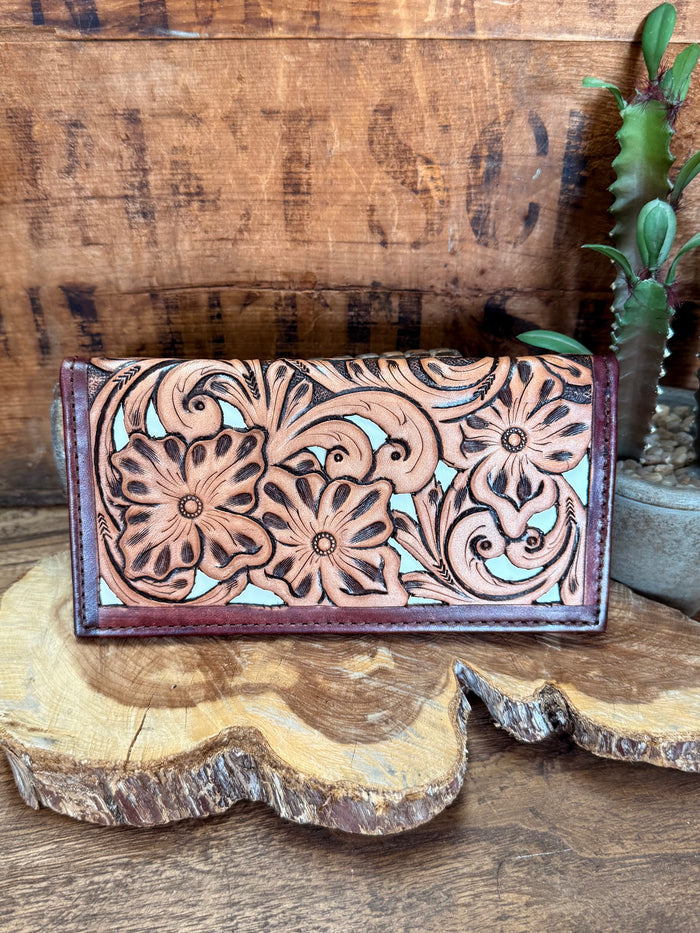 Floral tooled checkbook wallet front, detailed floral embossing on dark purple leather