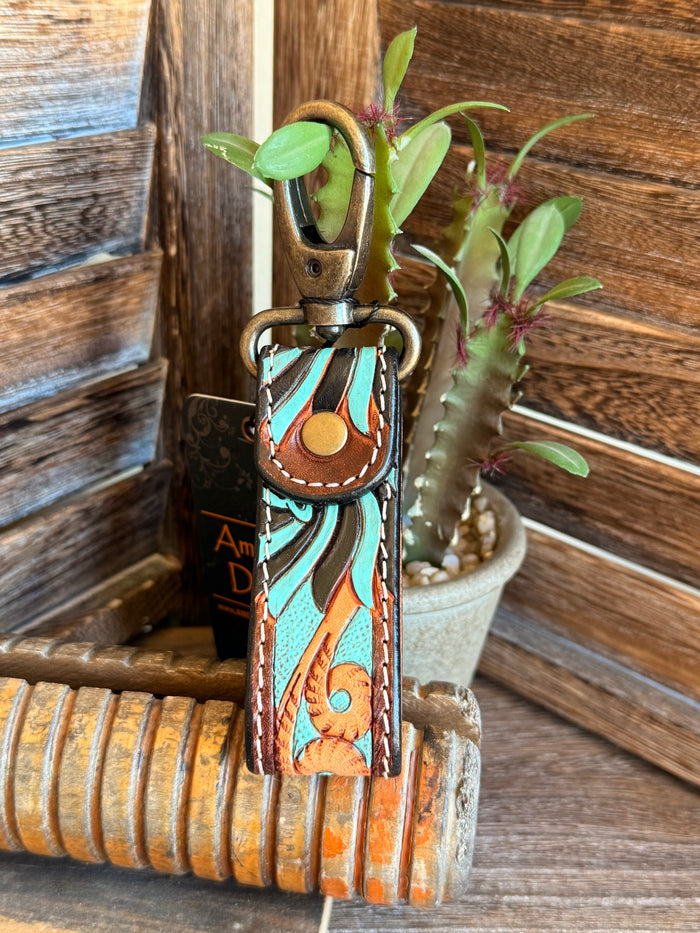 Turquoise tooled leather keychain with brass clip ring, patterned turquoise and orange