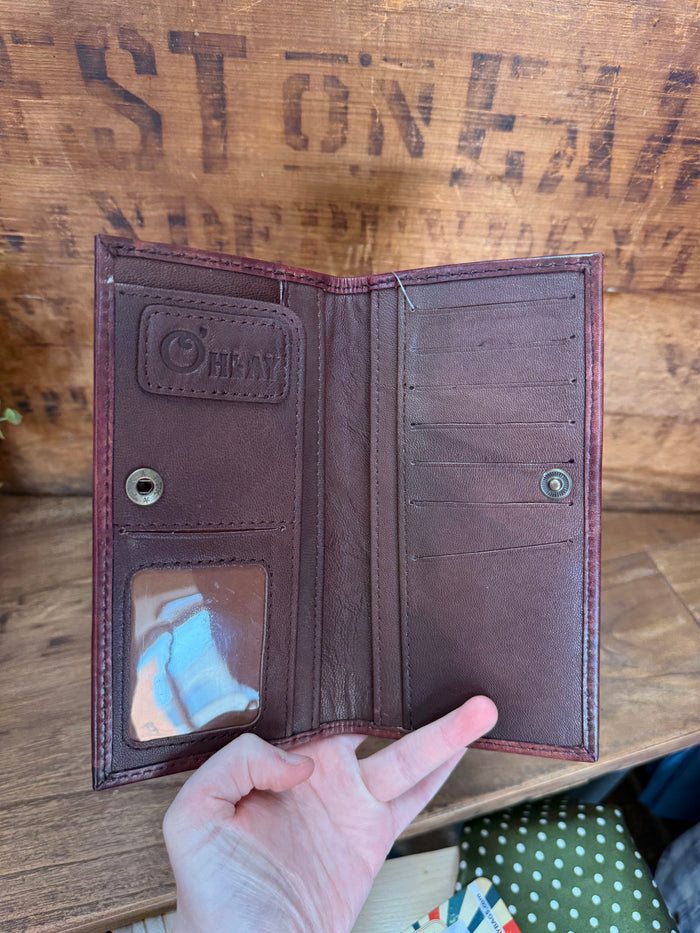 Opened checkbook wallet interior with card slots and snap closure on dark purple leather