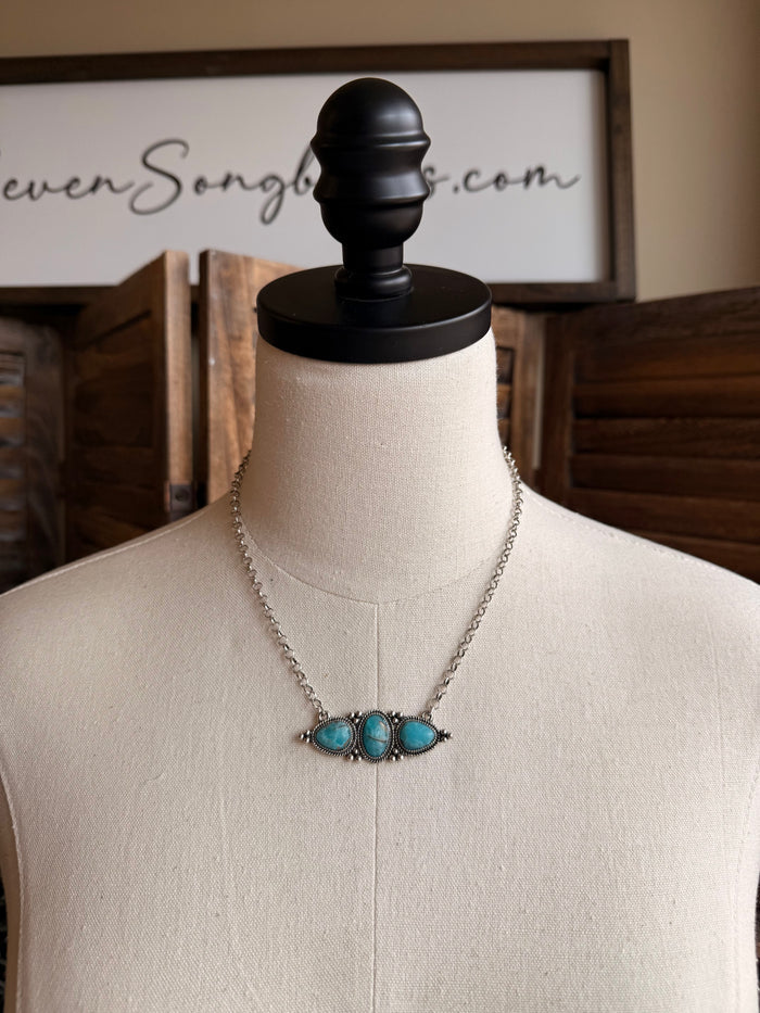 Turquoise triple-stone bar necklace with silver chain and three oval blue stones