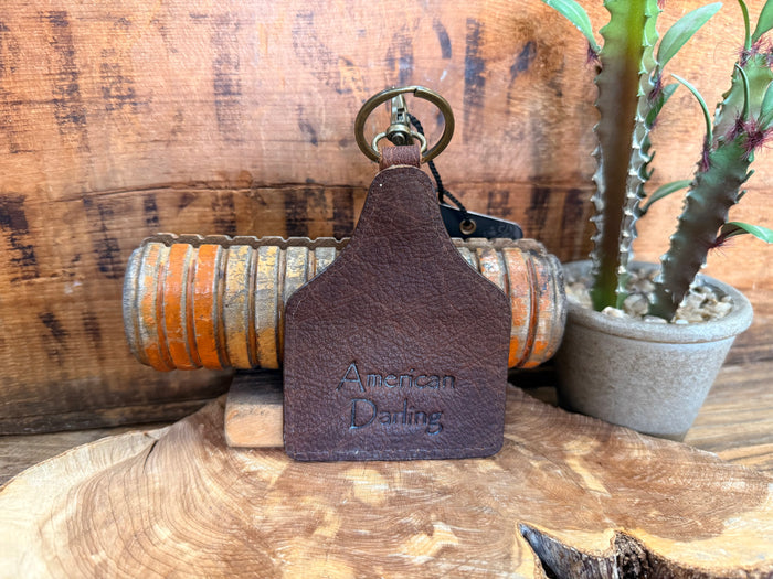 Cow skull hair-on key fob back with embossed 'American Darling' text
