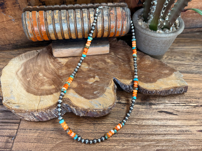 Turquoise and orange bead necklace with dark hematite-style beads and round spacer beads