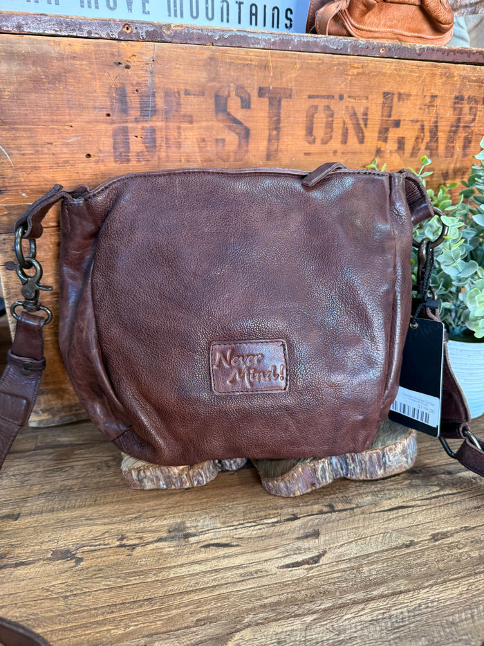 Chocolate brown crossbody purse with front logo patch and zip-top closure