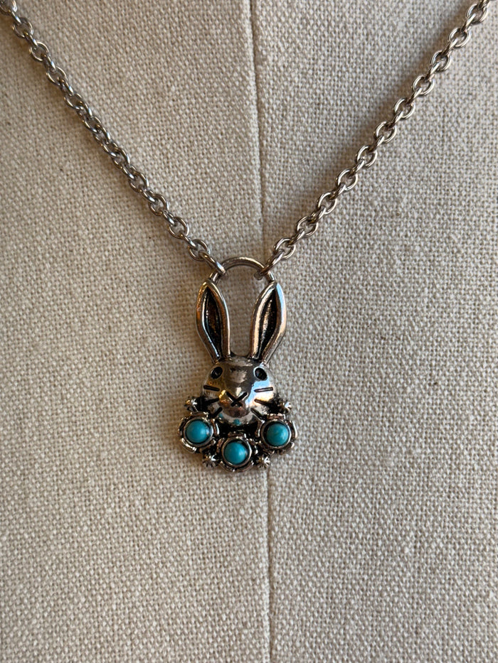 Bunny necklace charm with blue stones, silver chain and rabbit figure setting