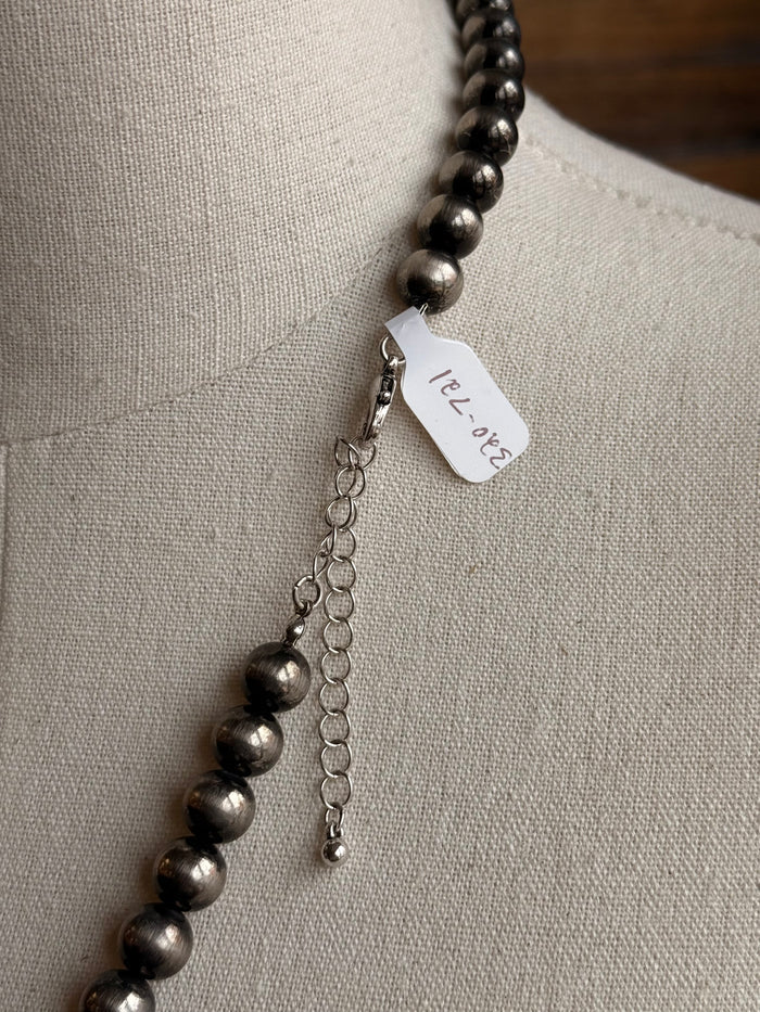 Metallic pearl bead necklace with dangling chain and engraved tag charm