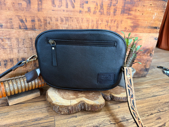 Dark blue leather crossbody purse with zip top, front pocket, adjustable shoulder strap