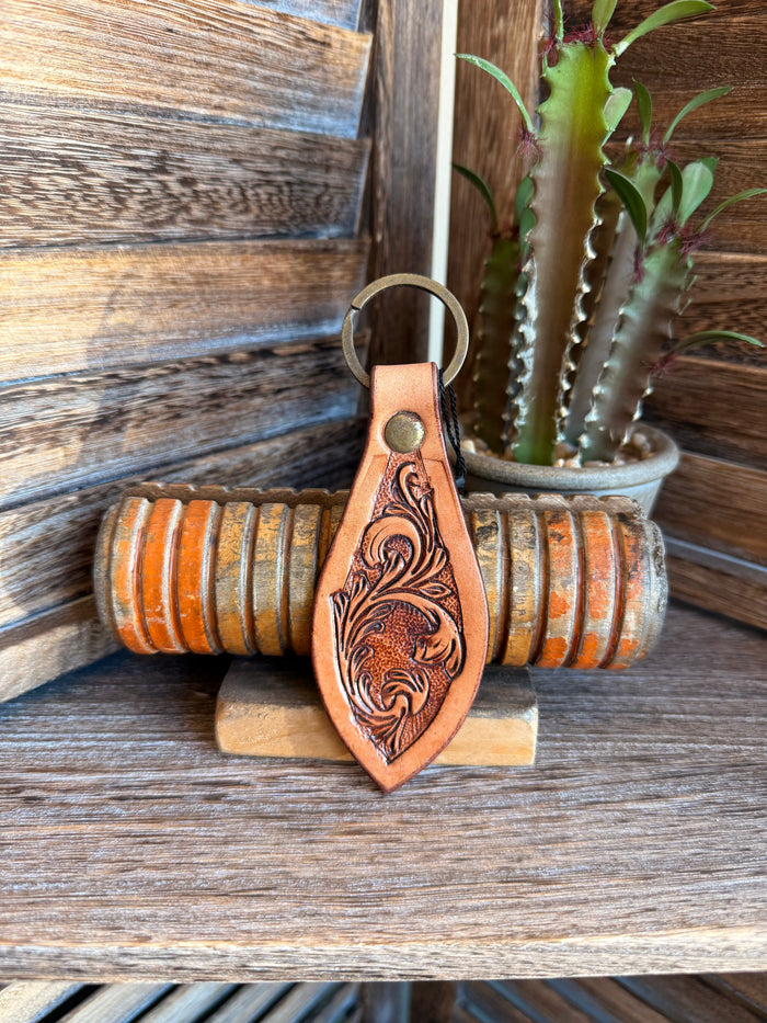 Brown leather keychain with embossed floral tooling and metal key ring
