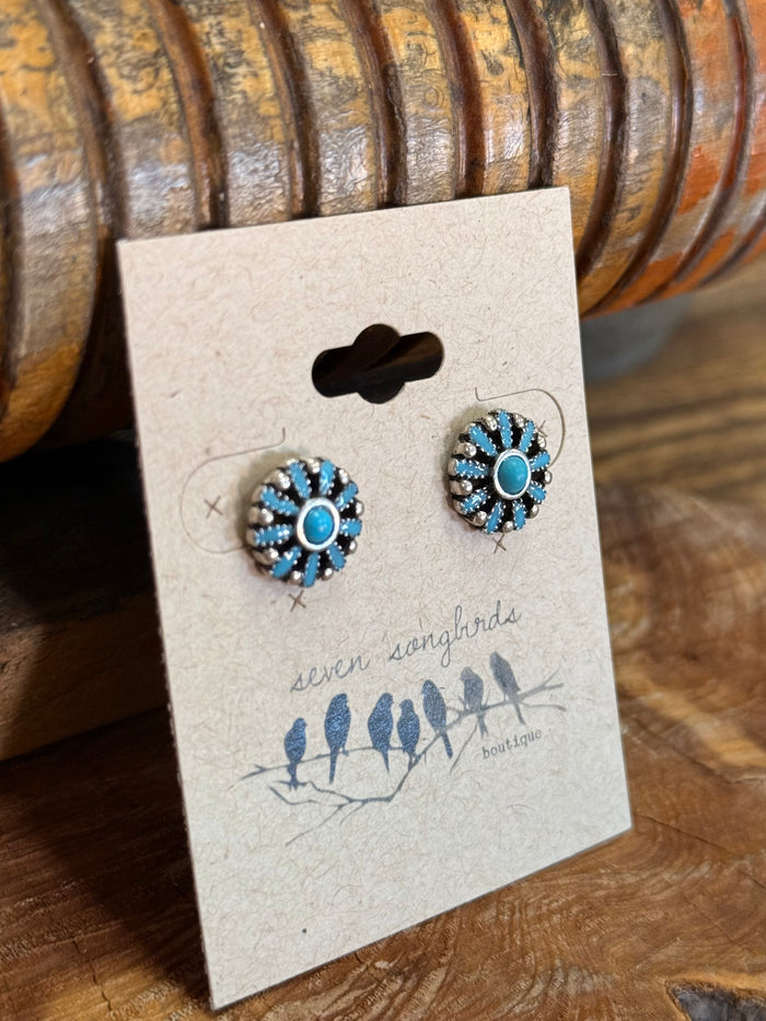 Turquoise flower stud earrings on display card, round silver-tone filigree with blue centers