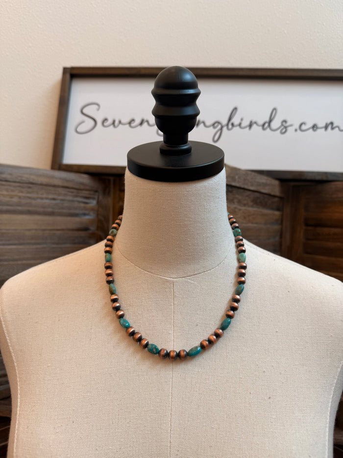 Copper and turquoise bead necklace with round beads on mannequin bust display