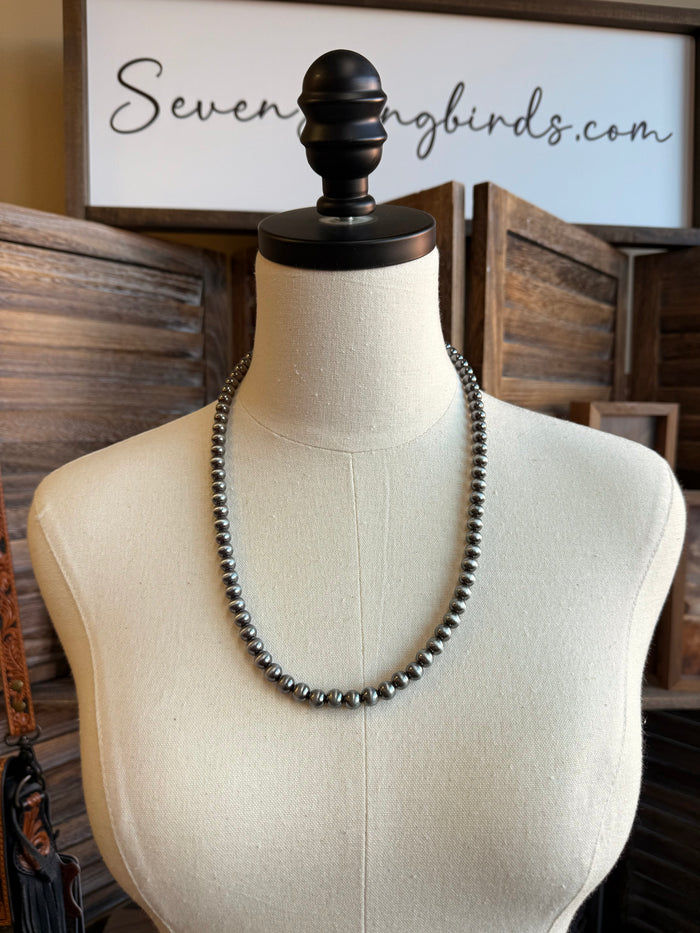 24-inch silver beaded ball chain necklace on a display bust