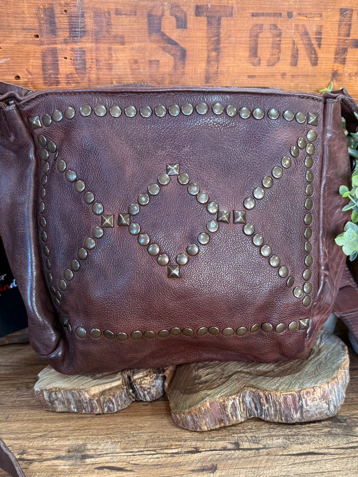 Chocolate brown crossbody purse with decorative stud pattern and zip-top closure