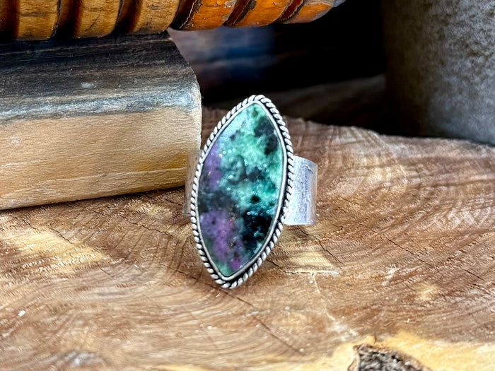 Close-up oval turquoise-green natural stone ring with silver-toned scalloped bezel