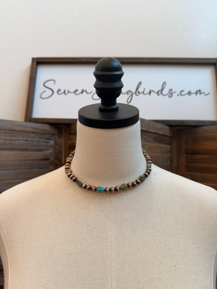 Turquoise and copper bead necklace on a mannequin torso