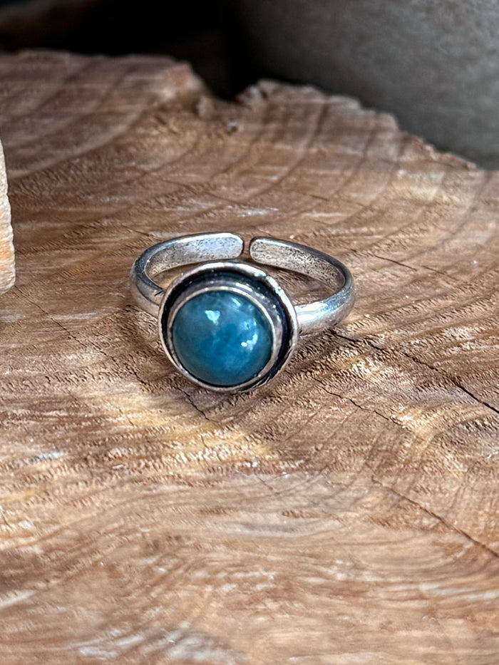 Silver-tone adjustable ring with large round blue stone and textured bezel