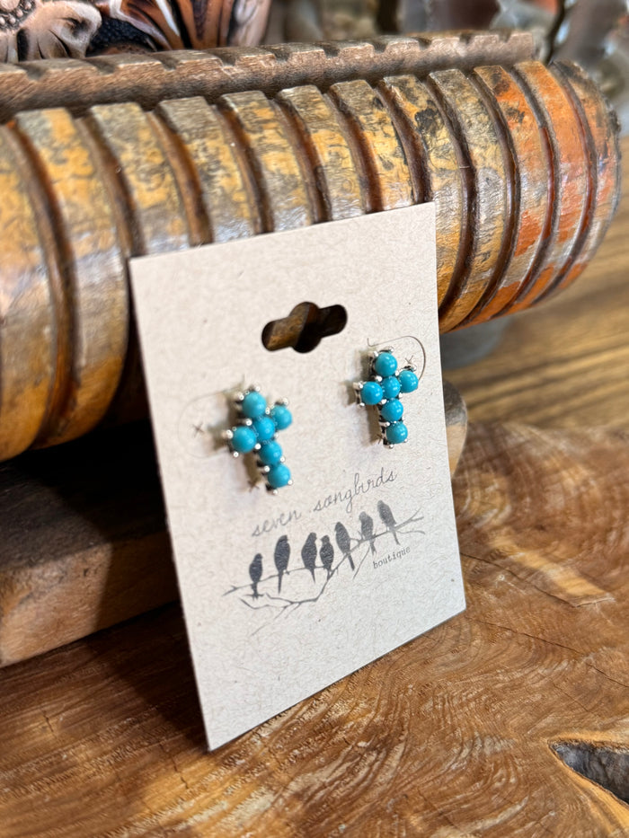 Turquoise beaded cross stud earrings with silver-tone posts, angled view
