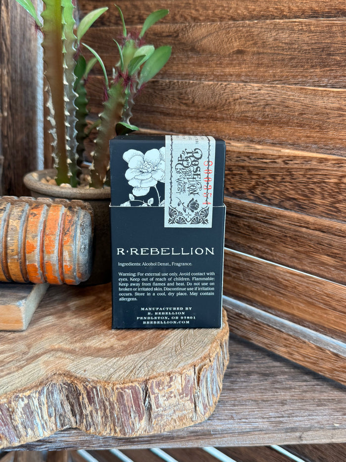50 mL perfume box back, black with white floral illustration and small ingredient text